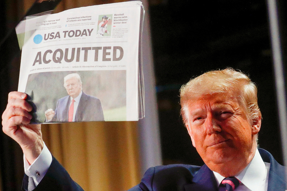 File picture of Donald Trump holding up a copy of USA Todayu00e2u20acu2122s front page showing news of his acquittal in his Senate impeachment trial, as he arrives to address the National Prayer Breakfast in Washington, US, February 6, 2020. u00e2u20acu201d Reuters picnn