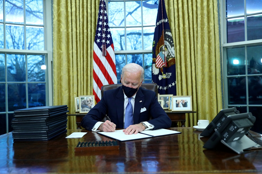 US President Joe Biden signs executive orders in the Oval Office of the White House in Washington, after his inauguration as the 46th President of the United States January 21, 2021. u00e2u20acu2022 Reuters pic