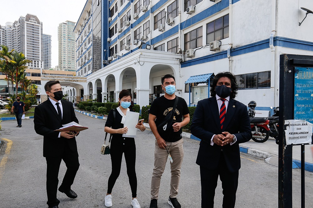 Lawyer Dev Kumaraendran (right) escorting 41-year-old man (second right) and his wife George Town district police headquarters at Jalan Patani, January 13, 2021. u00e2u20acu2022 Picture by Sayuti Zainudin
