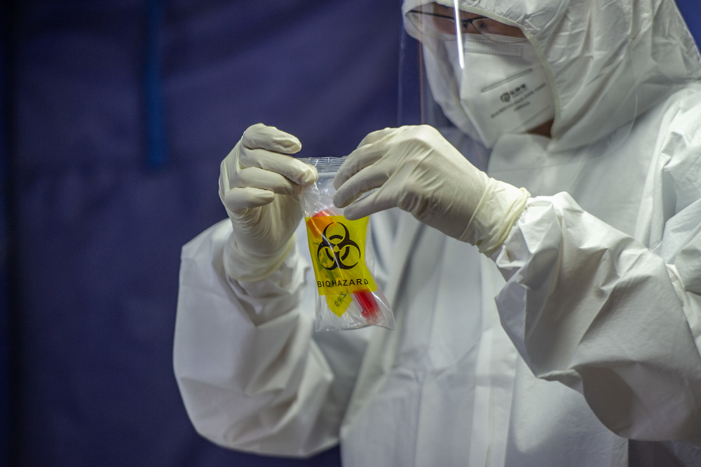 A health worker puts a test tube into biohazard plastic after collecting a sample for Covid-19 testing in Jalan Pudu, Kuala Lumpur, January 18, 2021. u00e2u20acu201d Picture by Shafwan Zaidon