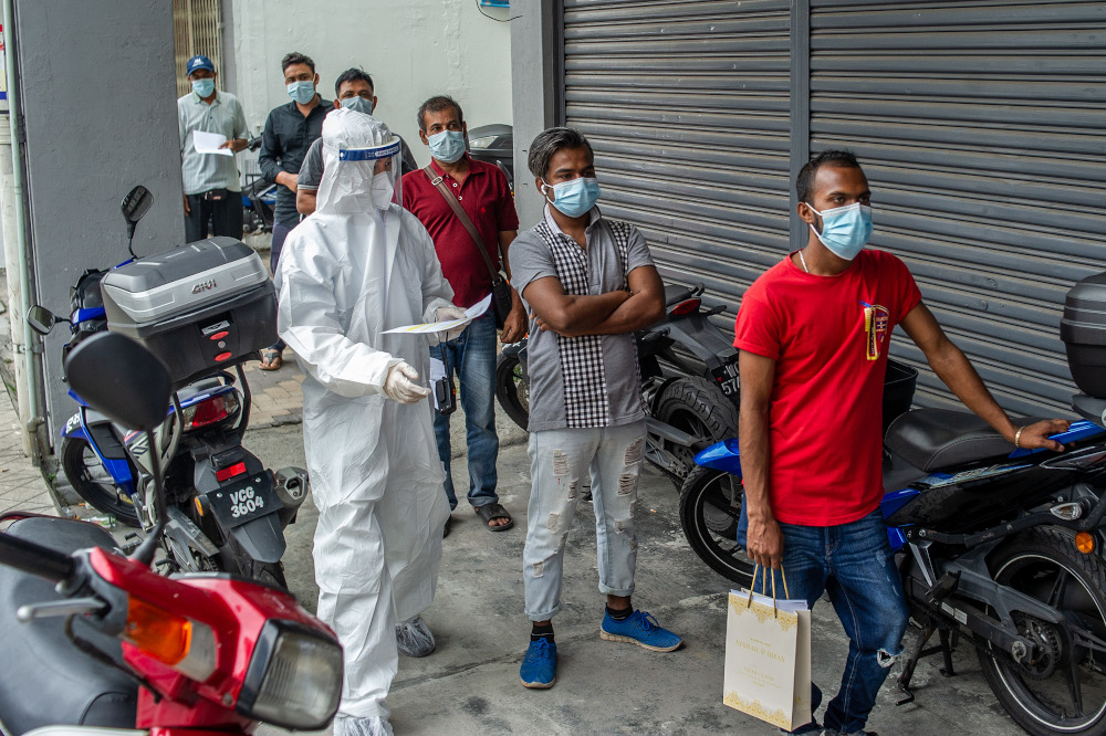 Workers waiting in line for a Covid-19 test in Jalan Pudu, Kuala Lumpur, January 18, 2021. u00e2u20acu201d Picture by Shafwan Zaidon