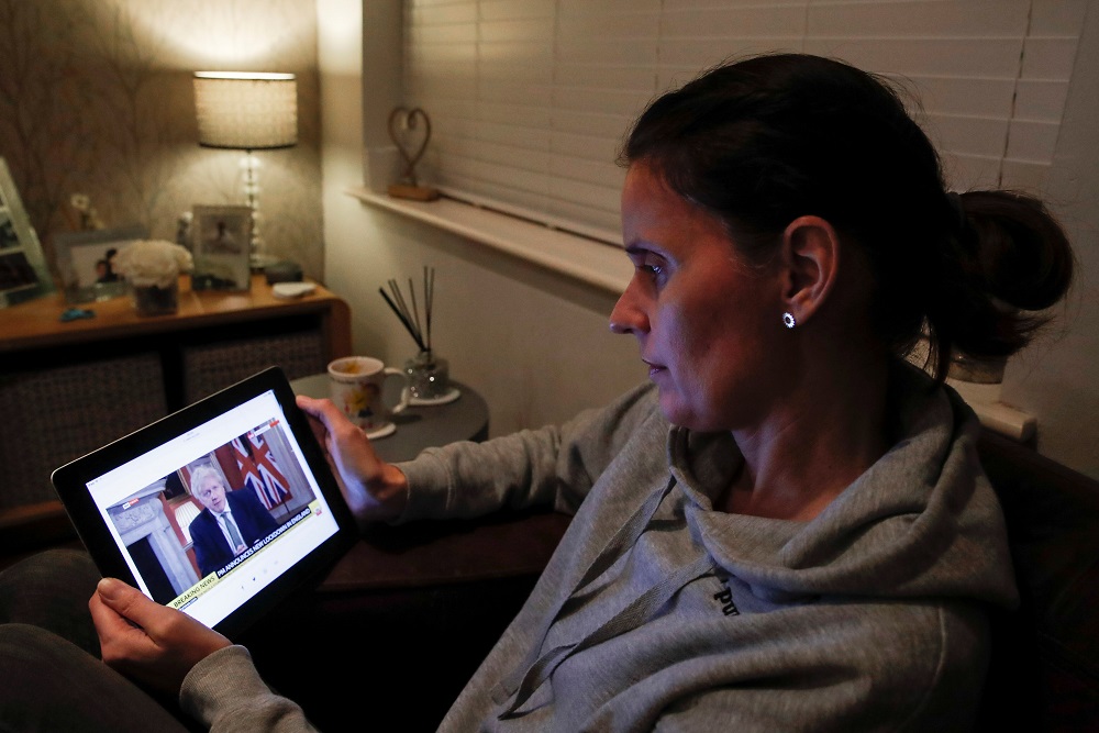 Teacher Wendy Couldridge watches on a device as Britain's Prime Minister Boris Johnson announces a lockdown in England, amid the coronavirus disease outbreak, in Hertford, Britain January 4, 2021. u00e2u20acu2022 Reuters pic