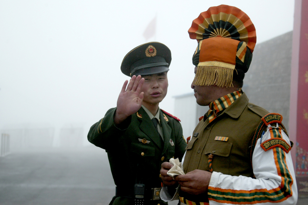 In this file photo taken July 10, 2008 a Chinese soldier gestures as he stands near an Indian soldier on the Chinese side of the ancient Nathu La border crossing between India and China. u00e2u20acu201d AFP picnn