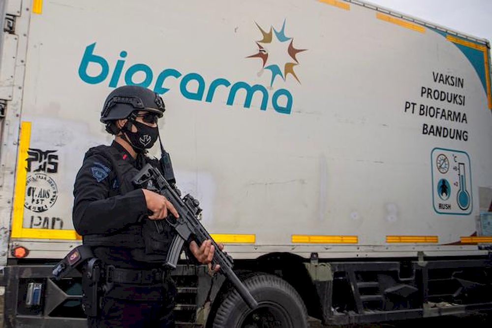 An armed police officer stands guard next to a truck containing Sinovacu00e2u20acu2122s vaccine for Covid-19 as it arrives at the cold room of Indonesiau00e2u20acu2122s local health department in Palembang, South Sumatra province, Indonesia, January 4, 2021. u00e2u20acu201d Antara Foto pic 