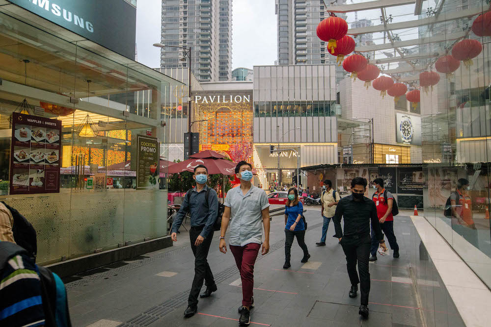 People wearing facemasks are seen walking on a street in Kuala Lumpur amid the Covid-19 outbreak, February 16, 2021. u00e2u20acu201d Picture by FIrdaus Latif