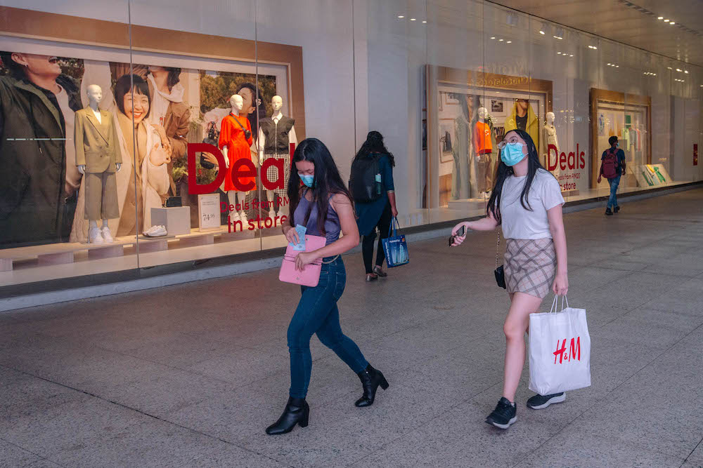 People wearing facemasks are seen walking outside a shopping mall in Kuala Lumpur amid the Covid-19 outbreak, February 16, 2021. u00e2u20acu201d Picture by FIrdaus Latif
