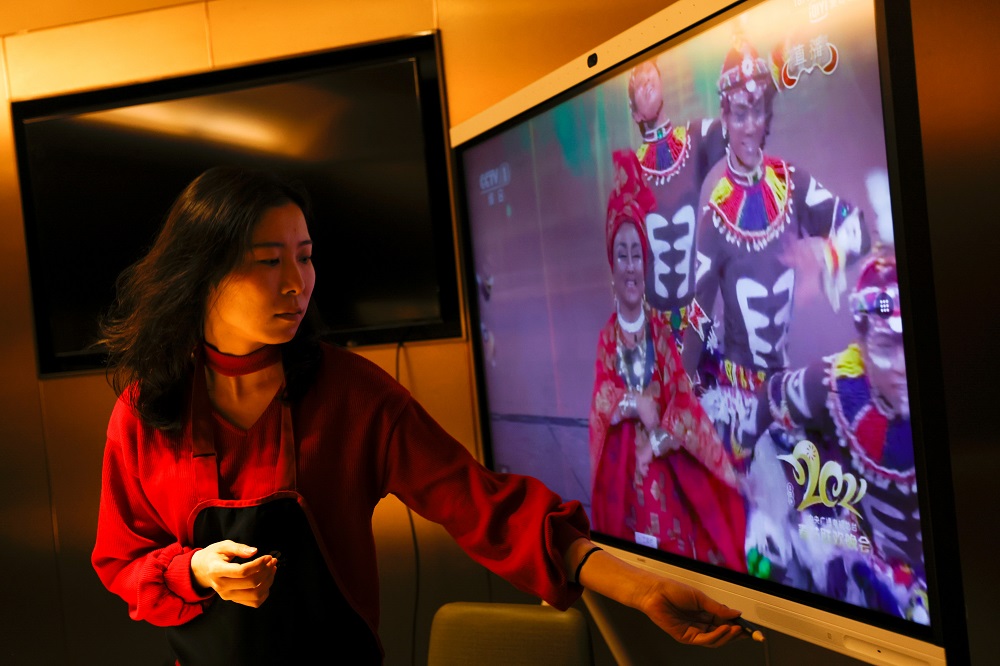 Liu Yuting controls the screen while watching the Lunar New Year gala after having dinner with her family at a Haidilao hotpot restaurant, in Beijing February 11, 2021. u00e2u20acu201d Reuters pic