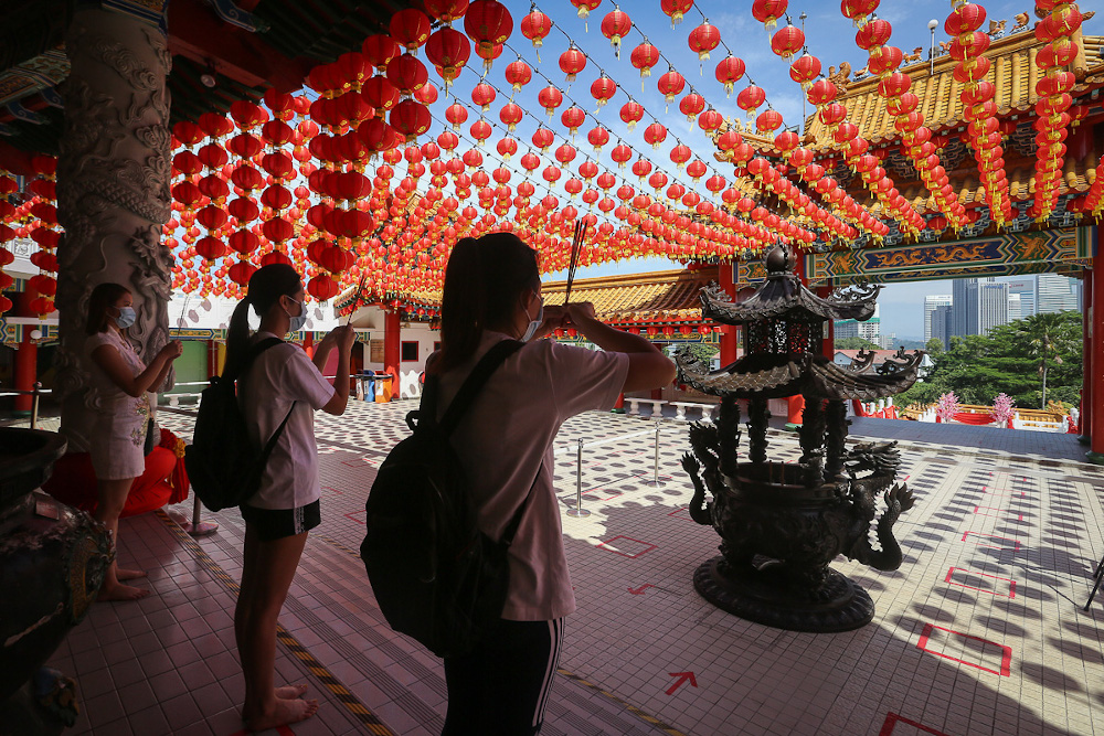 Worshippers wearing protective masks pray during the Chinese New Yearu00e2u20acu2122s Eve at the Thean Hou Temple in Kuala Lumpur February 11, 2021. u00e2u20acu201d Picture by Yusof Mat Isa