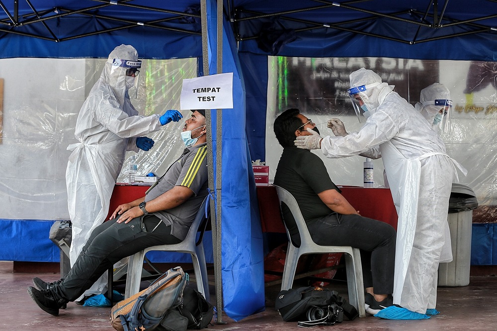 Health workers collect swab samples to test for Covid-19 at Dewan Kebajikan Gombak Setia February 20, 2021. u00e2u20acu201d Picture by Ahmad Zamzahuri