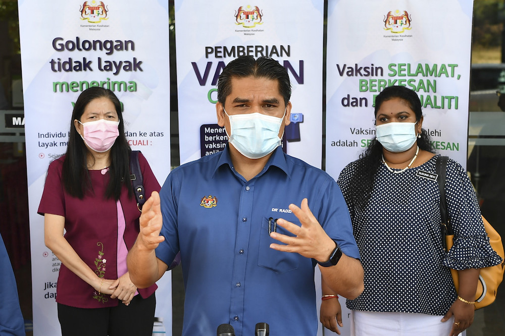 Education Minister Datuk Dr Radzi Jidin speaks to media after getting the Pfizer BioNTech Covid-19 jab at the Putrajaya Health Office, Presinct 11, February 27, 2021. u00e2u20acu201d Bernama pic