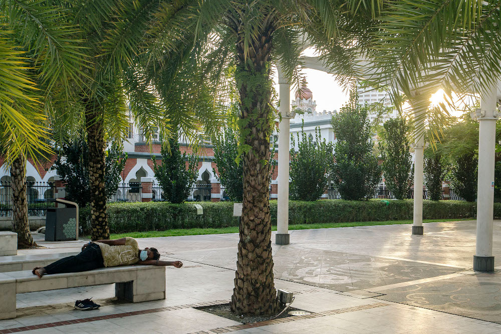 A homeless man is seen sleeping on a public bench during the implementation of the movement control order (MCO 2.0) in Kuala Lumpur February 2, 2021. u00e2u20acu201d Picture by Firdaus Latif