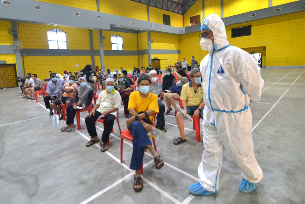 People attend Covid-19 screening in Puchong on February 28,2021. u00e2u20acu201d Picture by Miera Zulyana