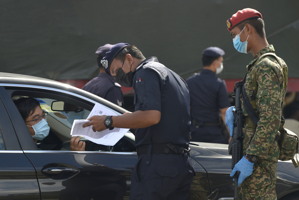 Soldiers and police officers conduct roadblock checks during movement control order 2.0 (MCO) in Subang Jaya, February 2, 2021. u00e2u20acu201d Picture by Miera Zulyana