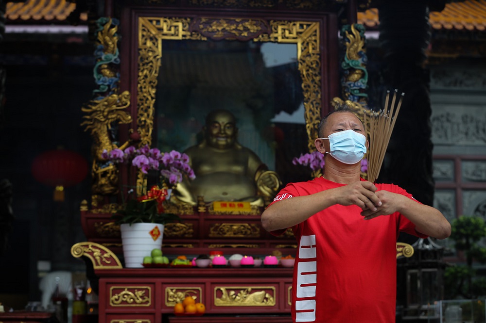 A devotee performs prayers at the Kuan Yin Temple in Klang February 12, 2021. u00e2u20acu2022 Picture by Yusof Mat Isa