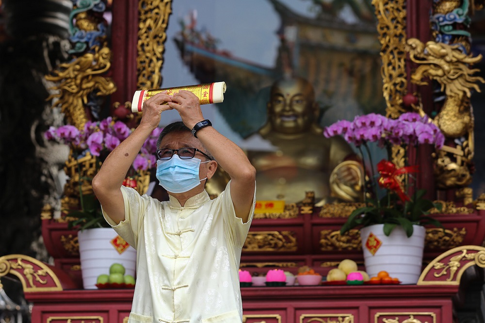 A devotee performs prayers at the Kuan Yin Temple in Klang February 12, 2021. u00e2u20acu2022 Picture by Yusof Mat Isa