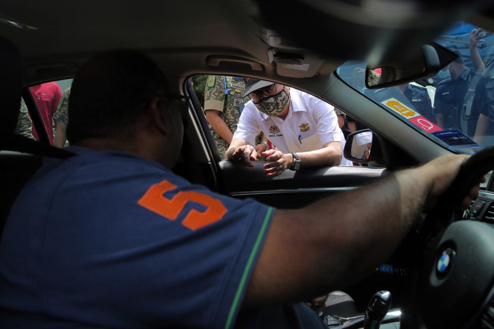 Senior Minister Datuk Seri Ismail Sabri Yaakob speaks to a motorist at a roadblock at the Gombak Toll Plaza in Kuala Lumpur February 1, 2021. u00e2u20acu201d Bernama pic