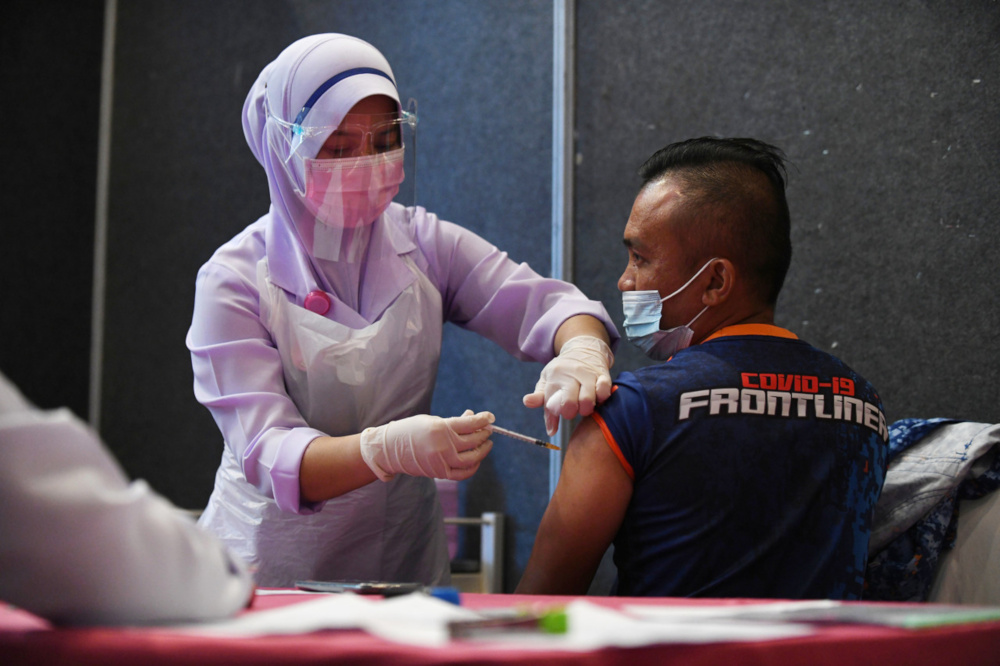 A frontliner receives the Pfizer BioNTech Covid-19 vaccine at the Kuantan Vaccination Centre at Dewan Jubli Perak Sultan Ahmad Shah in Kuantan, February 26, 2021. u00e2u20acu201d Bernama pic 