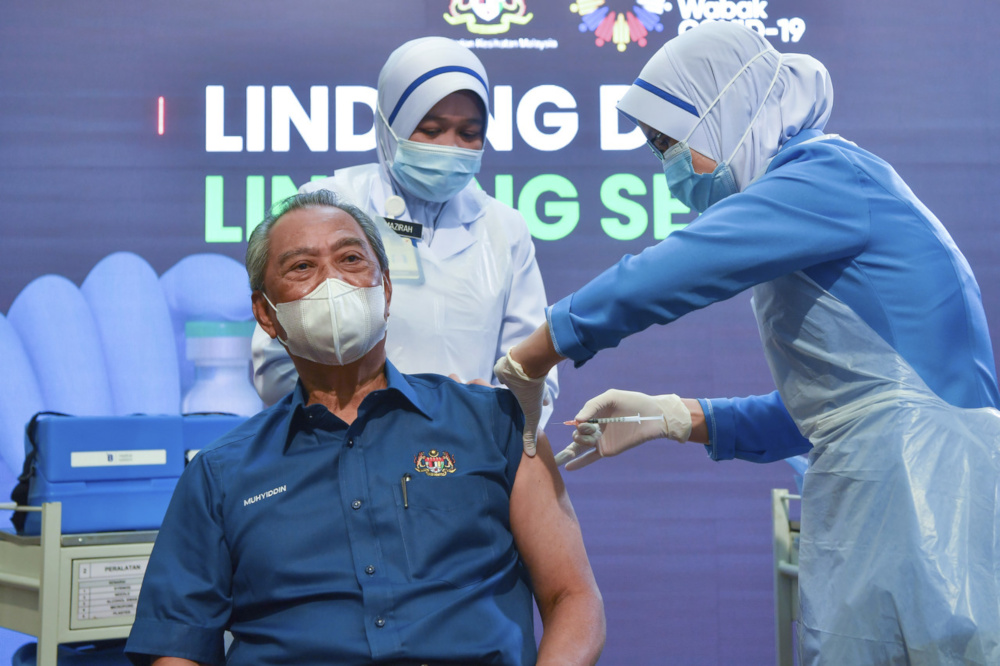 Prime Minister Tan Sri Muhyiddin Yassin receives the Pfizer BioNTech Covid-19 vaccine from Chief Nurse Lina Ibrahim at the Putrajaya District Health Office Precinct 11 February 24, 2021. u00e2u20acu201d Bernama pic 
