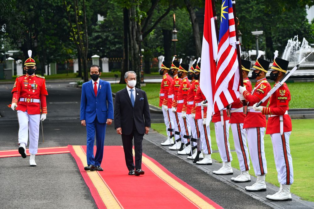 Malaysian Prime Minister Tan Sri Muhyiddin Yassin and Indonesian President Joko Widodo walk during a welcoming ceremony at the Presidential Palace in Jakarta February 5, 2021. u00e2u20acu201d Reuters pic