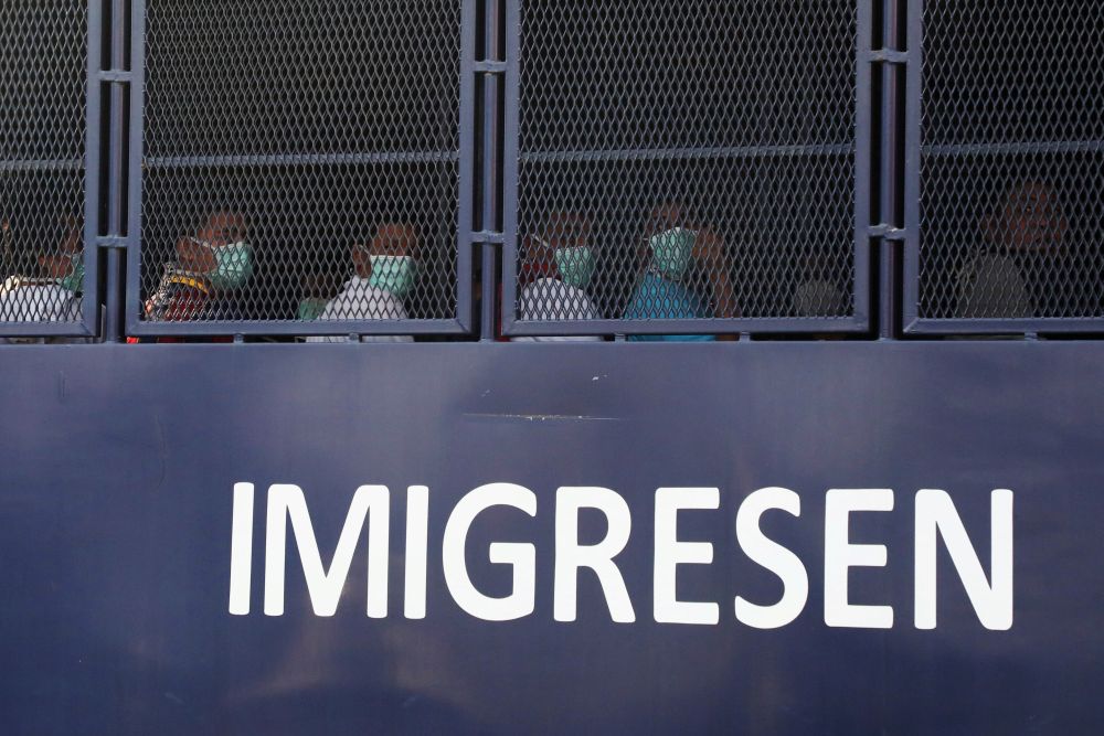 Myanmar migrants to be deported from Malaysia are seen inside an immigration truck, in Lumut February 23, 2021. u00e2u20acu201d Reuters picnn