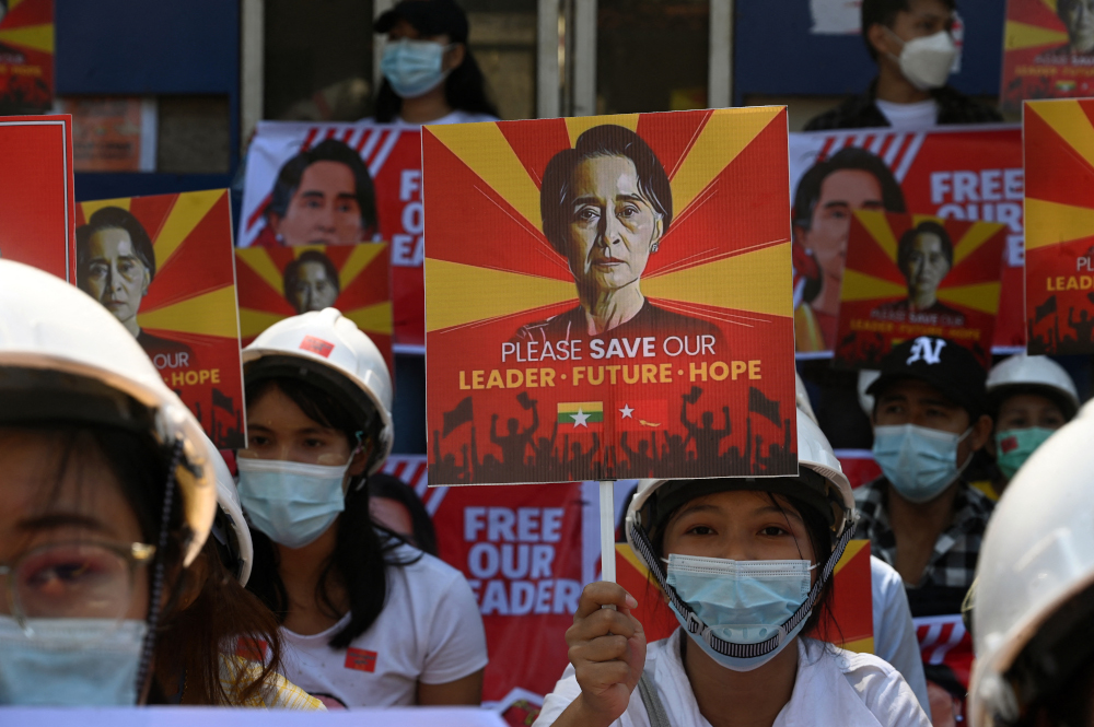 Protesters hold signs calling for the release of detained Myanmar civilian leader Aung San Suu Kyi at a demonstration against the military coup in Yangon February 14, 2021. u00e2u20acu201d AFP pic