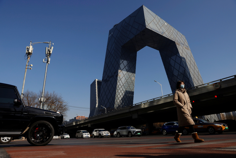 A woman wearing a face mask following the Covid-19 outbreak walks past the CCTV headquarters, the home of Chinese state media outlet CCTV and its English-language sister channel CGTN, in Beijing February 5, 2021. u00e2u20acu201d Reuters pic