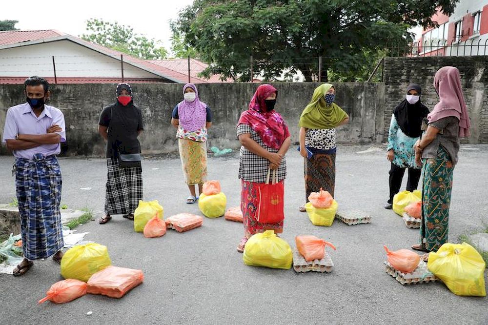 File picture shows Rohingya refugees wearing protective masks keep a social distance while waiting to receive goods from volunteers, during the movement control order due to the outbreak of the coronavirus, in Kuala Lumpur, April 7, 2020. u00e2u20acu201d Reuters pic