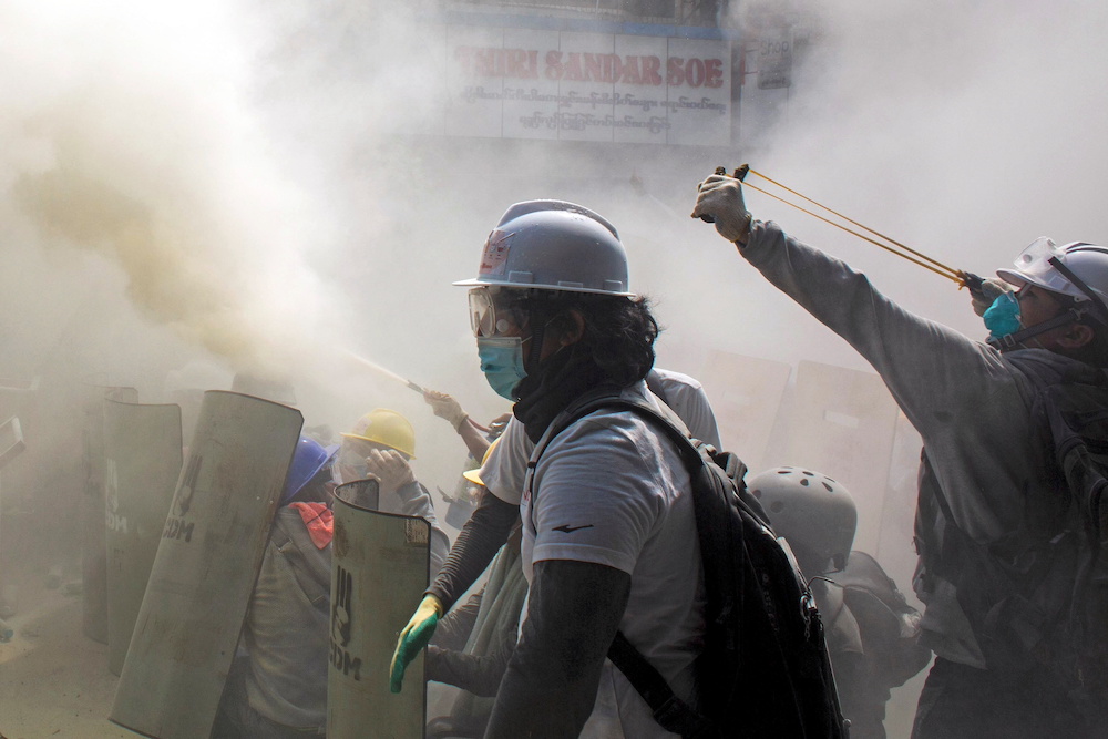 A protester uses a slingshot as demonstrators clash with riot police officers during a protest against the military coup in Yangon, Myanmar February 28, 2021. u00e2u20acu201d Reuters pic 