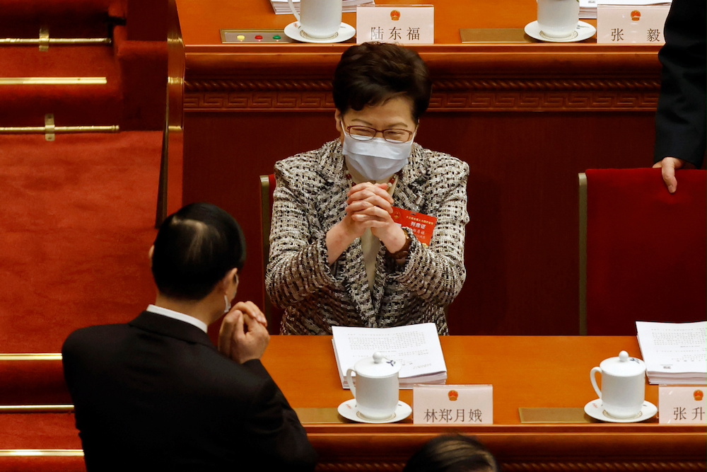 Hong Kong Chief Executive Carrie Lam greets a Chinese delegate before the opening session of the National People's Congress (NPC) at the Great Hall of the People in Beijing, China March 5, 2021. u00e2u20acu201d Reuters pic