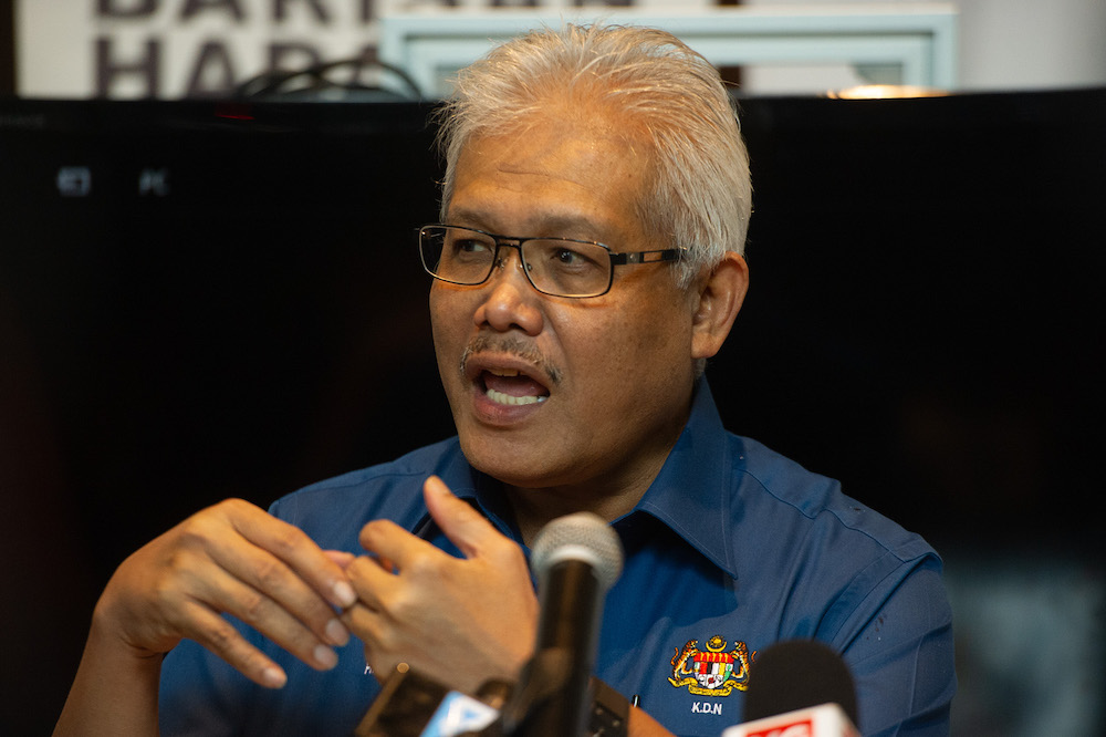 Minister of Home Affairs Datuk Seri Hamzah bin Zainudin speaks to the media during the launch of the Mobile National Registration Department bus at the National Registration Department in Putrajaya, March 18, 2021. u00e2u20acu201d Picture by Shafwan Zaidon