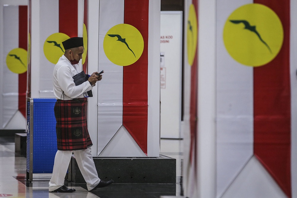An Umno member arrives for the 2021 Umno annual general assembly in Kuala Lumpur March 27, 2021. u00e2u20acu2022 Picture by Hari Anggara