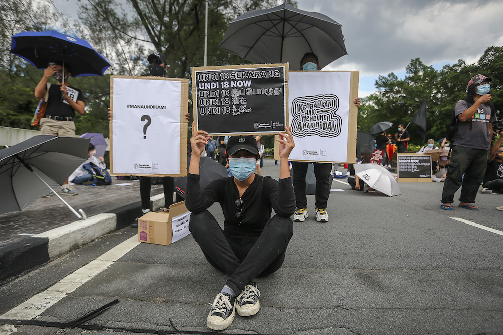 Protesters hold placards in front of Parliament building to protest the Election Commission's (EC) delay in allowing 18-years old to vote in Kuala Lumpur March 27, 2021. u00e2u20acu201dPicture by Yusof Mat Isa