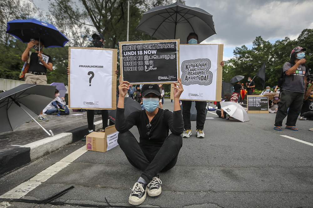 Protesters hold placards in front of Parliament building to protest the Election Commission's (EC) delay in allowing 18-years old to vote in Kuala Lumpur March 27, 2021. u00e2u20acu201dPicture by Yusof Mat Isa