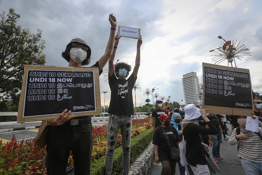 Protesters hold placards in front of Parliament building to protest the Election Commission's (EC) delay in allowing 18-years old to vote in Kuala Lumpur March 27, 2021. u00e2u20acu201dPicture by Yusof Mat Isa