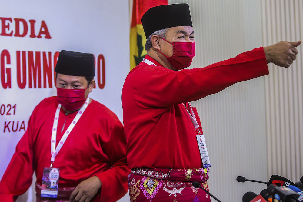 Umno president Datuk Seri Ahmad Zahid Hamidi (centre) speak to reporters during the press conference at the 2020 Umno annual general meeting in Kuala Lumpur March 28, 2021. u00e2u20acu2022 Picture by Hari Anggarann