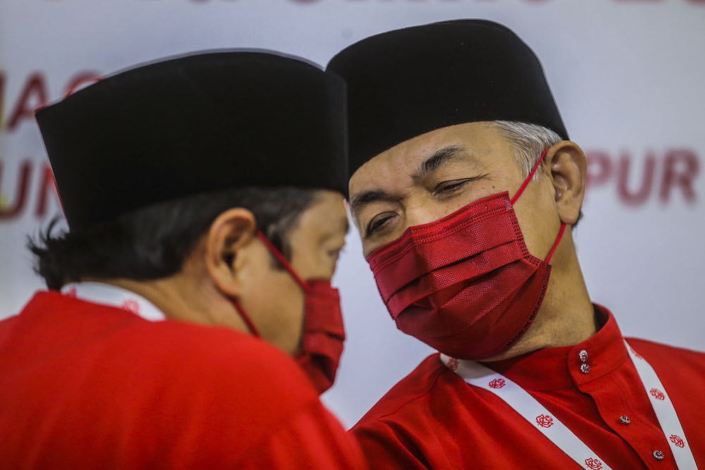 Umno president Datuk Seri Ahmad Zahid Hamidi (centre) speak to reporters during the press conference at the 2020 Umno annual general meeting in Kuala Lumpur March 28, 2021. u00e2u20acu2022 Picture by Hari Anggarann