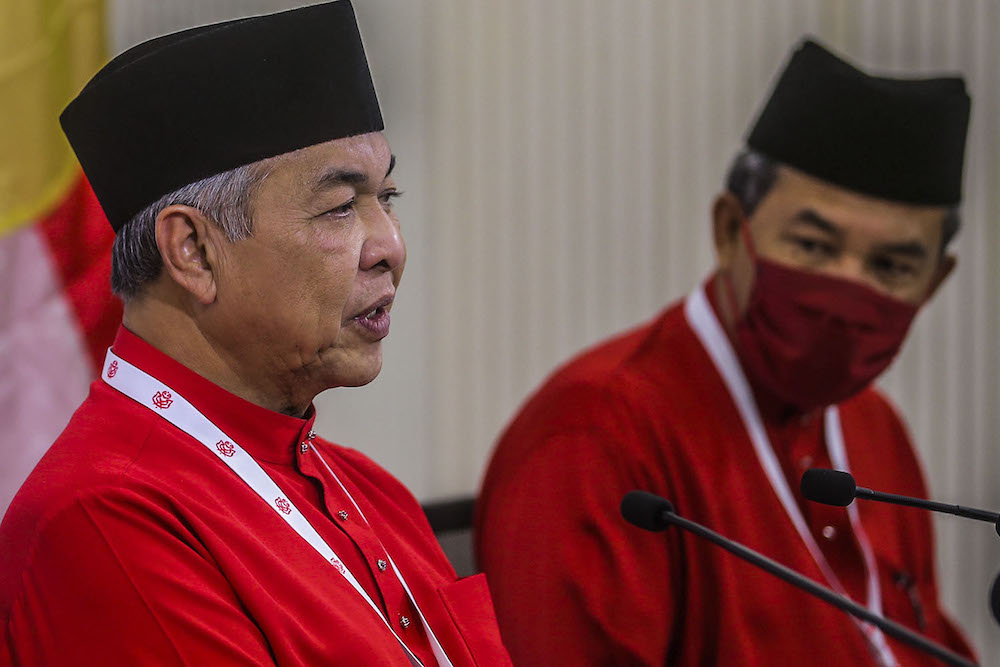 Umno president Datuk Seri Ahmad Zahid Hamidi (centre) speak to reporters during the press conference at the 2020 Umno annual general meeting in Kuala Lumpur March 28, 2021. u00e2u20acu2022 Picture by Hari Anggarann