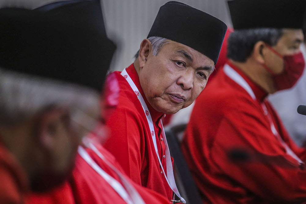 Umno president Datuk Seri Ahmad Zahid Hamidi (centre) speak to reporters during the press conference at the 2020 Umno annual general meeting in Kuala Lumpur March 28, 2021. u00e2u20acu2022 Picture by Hari Anggarann