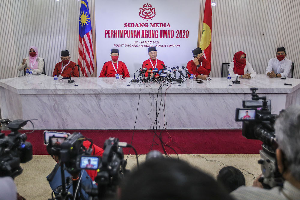 Umno president Datuk Seri Ahmad Zahid Hamidi (centre) speak to reporters during the press conference at the 2020 Umno annual general meeting in Kuala Lumpur March 28, 2021. u00e2u20acu2022 Picture by Hari Anggarann