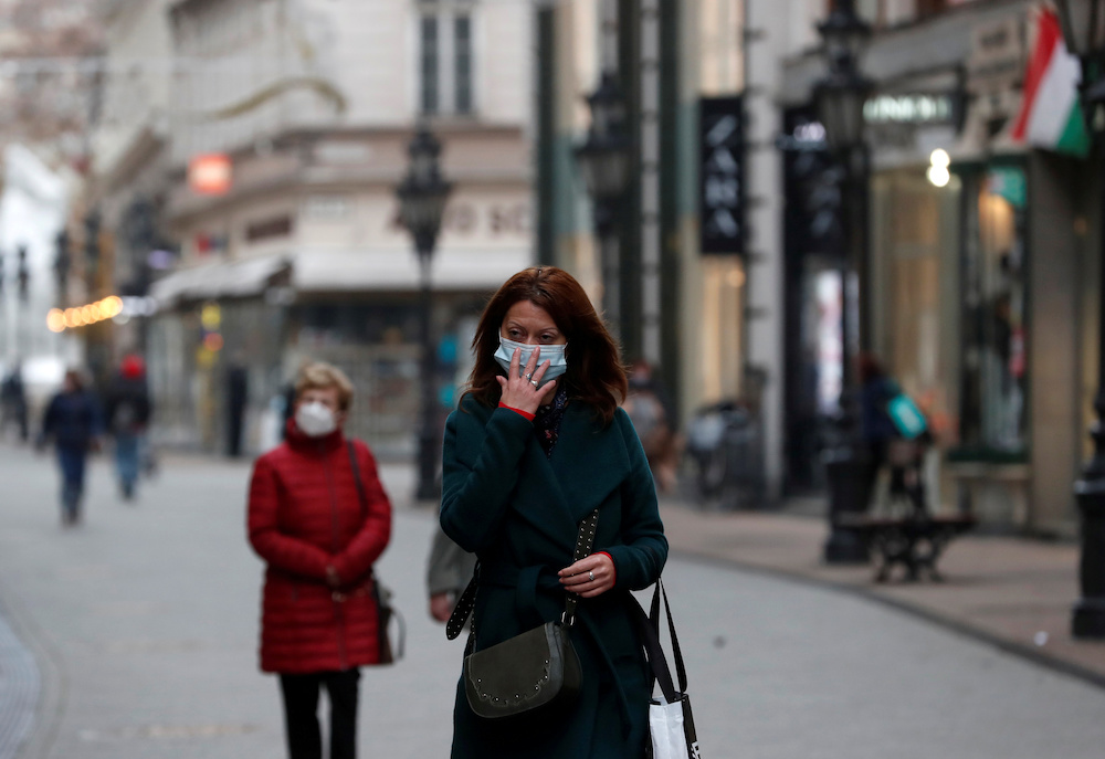 People wearing protective face masks walk in downtown Budapest, after Hungarian government imposed a nationwide lockdown to contain the spread of the coronavirus disease (Covid-19), Hungary, November 11, 2020. u00e2u20acu201d Reuters picnn n