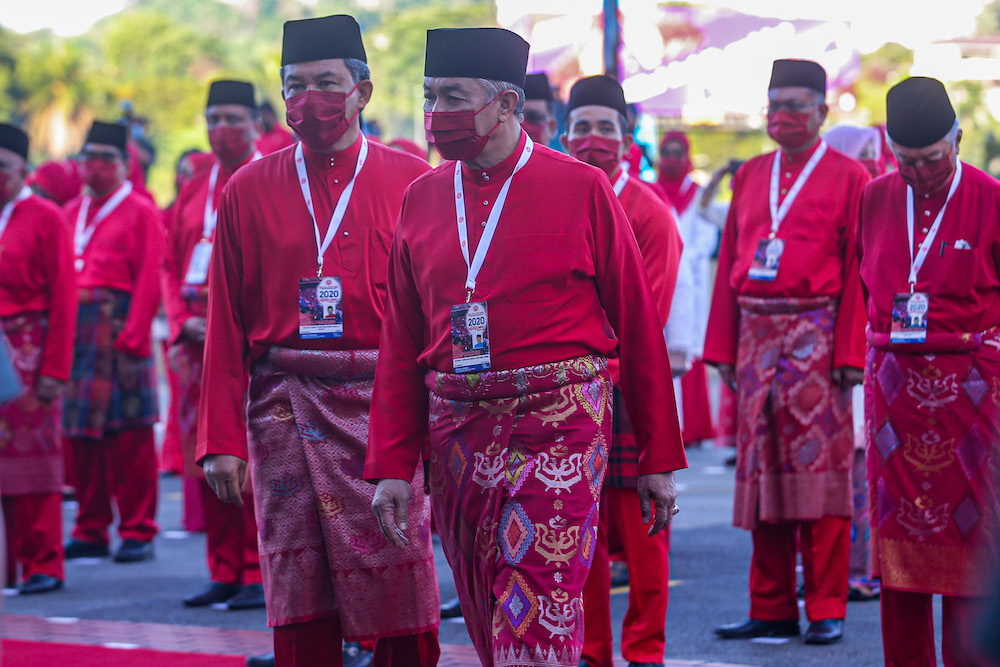 Umno president Datuk Seri Ahmad Zahid Hamidi (centre) arrives for the 2020 Umno general assembly in Kuala Lumpur March 28, 2021. u00e2u20acu201d Picture by Shafwan Zaidon