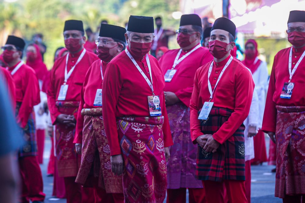 Umno president Datuk Seri Ahmad Zahid Hamidi (centre) arrives for the 2020 Umno general assembly in Kuala Lumpur March 28, 2021. u00e2u20acu201d Picture by Shafwan Zaidon