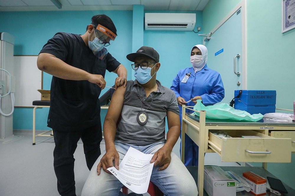 A health worker receives the Pfizer-BioNTech Covid-19 vaccine at the Klinik Kesihatan in Kelana Jaya March 6, 2021. u00e2u20acu2022 Picture by Yusof Mat Isa