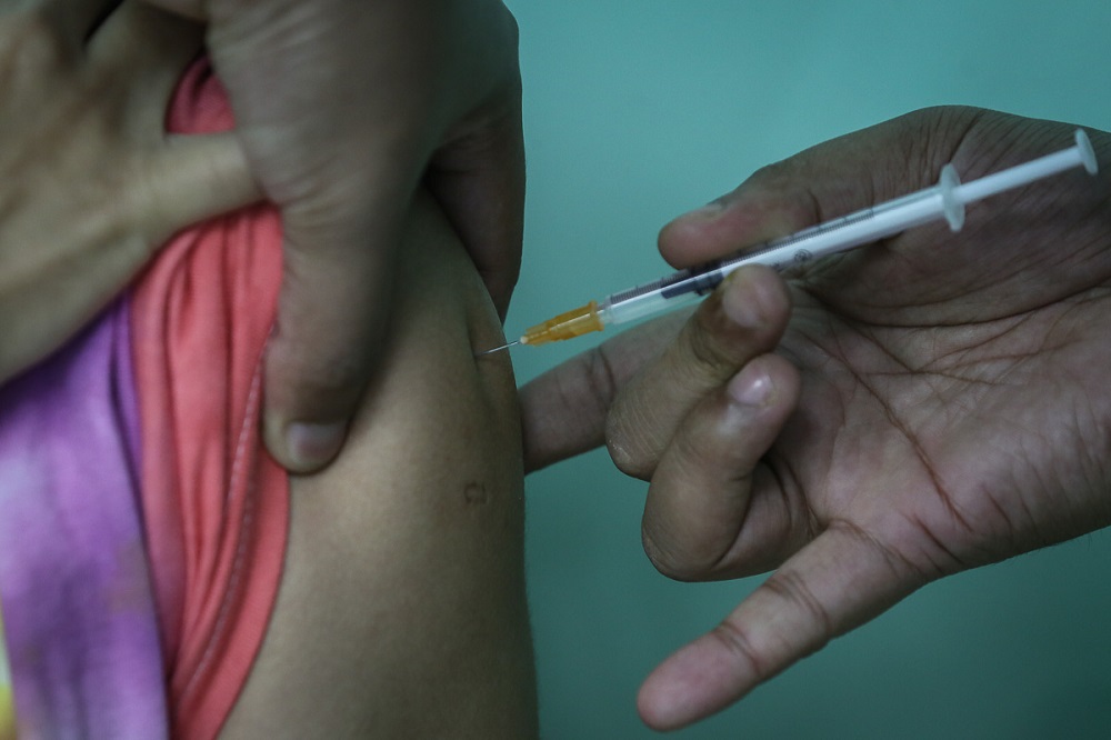 A health worker receives the Pfizer-BioNTech Covid-19 vaccine at the Klinik Kesihatan in Kelana Jaya March 6, 2021. u00e2u20acu2022 Picture by Yusof Mat Isa