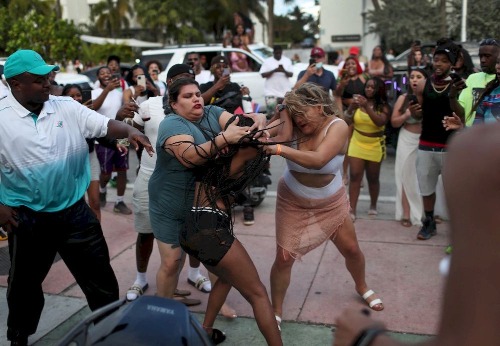 Women fight on the street near Ocean Drive on March 19, 2021 in Miami Beach, Florida. College students have arrived in the South Florida area for the annual spring break ritual. u00e2u20acu201d Getty Images via AFP