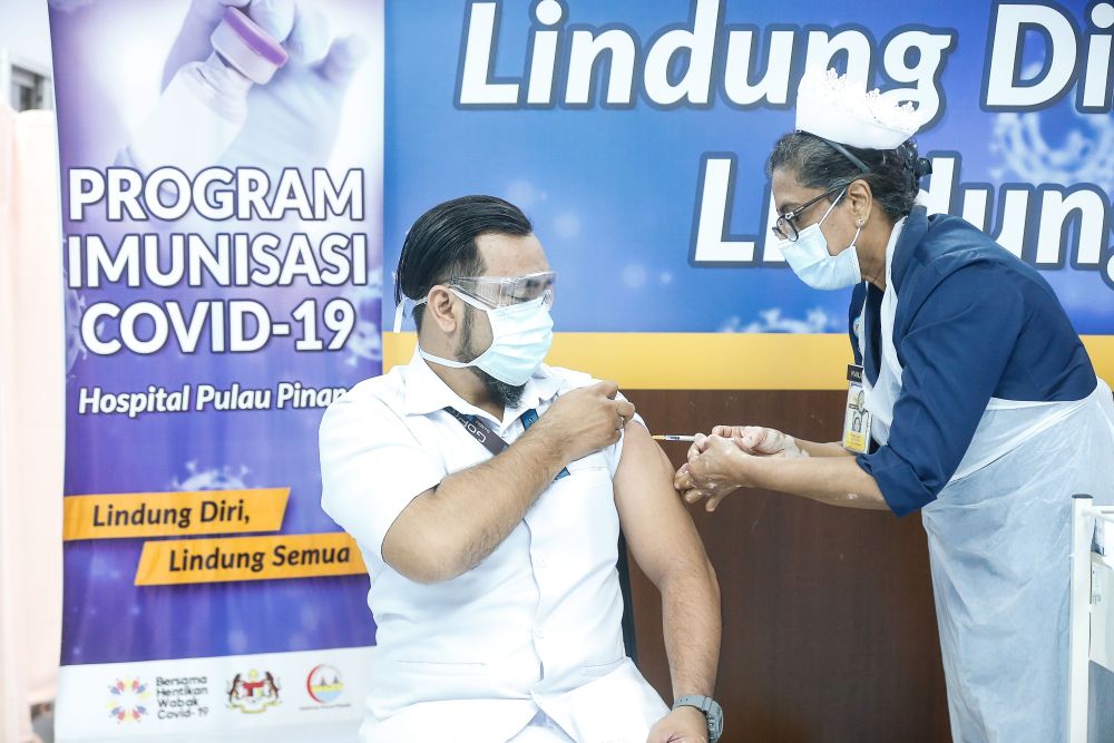A medical worker receives his Covid-19 jab at the Penang General Hospital in George Town March 2, 2021. u00e2u20acu201d Picture by Sayuti Zainudin