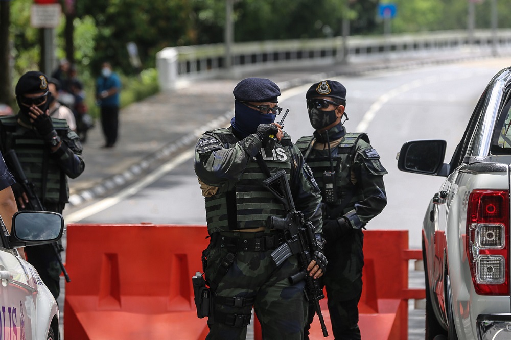 Police personnel stand guard at the road leading to Parliament in Kuala Lumpur March 27, 2021. u00e2u20acu2022 Picture by Yusof Mat Isa