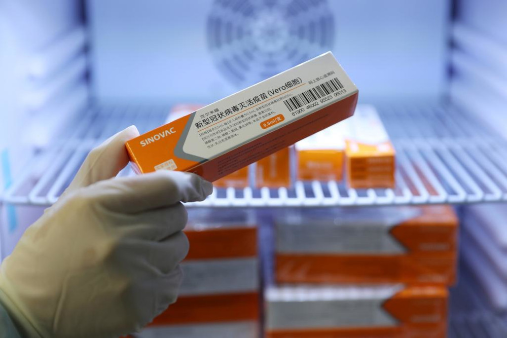 A medical worker takes a box of Sinovacu00e2u20acu2122s vaccine against the coronavirus disease from a refrigerator at a community health centre in Qingdao, Shandong province, China January 5, 2021. u00e2u20acu201d China Daily pic via Reutersnn