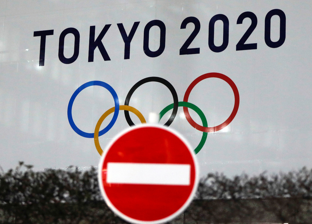 The logo of Tokyo 2020 Olympic Games that have been postponed to 2021 due to the coronavirus disease outbreak, is seen through a traffic sign at Tokyo Metropolitan Government Office building in Tokyo, Japan January 22, 2021. u00e2u20acu201d Reuters picnn
