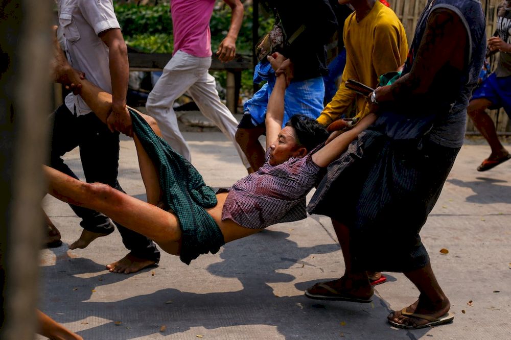 A resident, who was shot during a crackdown by security forces on demonstrations by protesters against the military coup, is carried to safety in Yangonu00e2u20acu2122s Hlaing Tharyar township on March 14, 2021. u00e2u20acu201d AFP pic